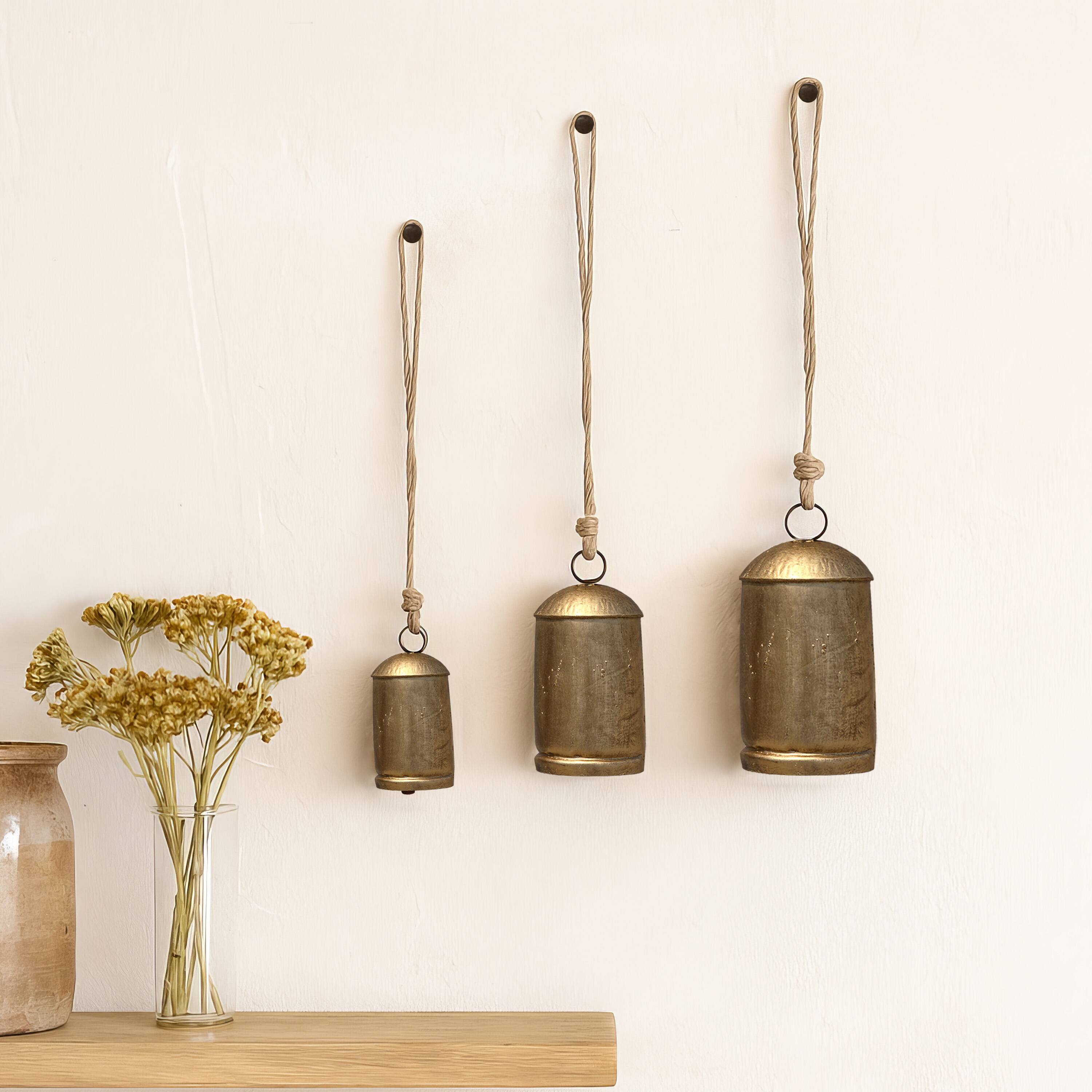 Alt View 9. Manhattan Lane - Zaira Decorative Iron Cow Bells Set of 3 | Cylindrical | Antique Gold Finish| Jute Hanging Rope | 20, 15, 12 Inches - Gold.