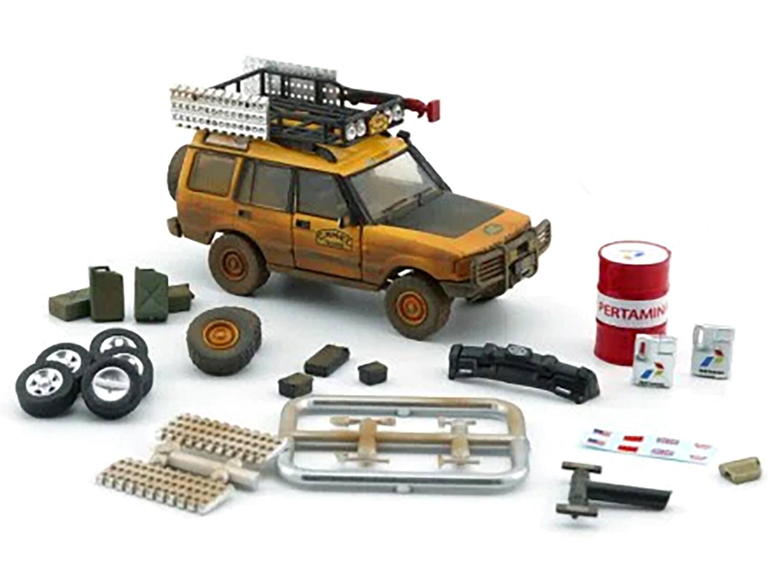 Angle. BM Creations - Land Rover Discovery 1 RHD "Camel Trophy" Yellow Mud Version w/ Roof Rack, Extra Wheels & Accessories 2016 pcs 1/64 - Yellow.