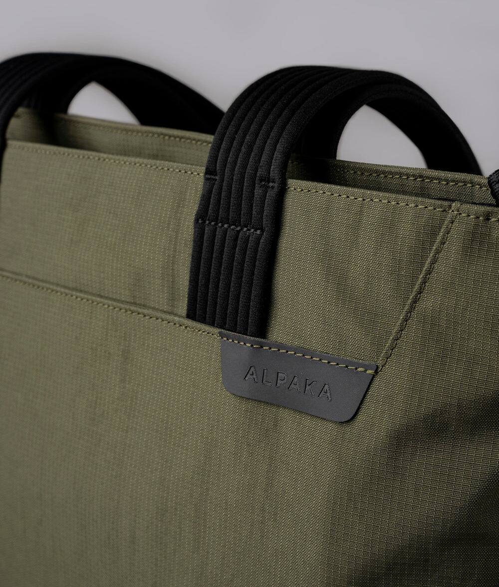 Alt View 6. ALPAKA - Flight Tote (M) Laptop Tote Bag for Work, Tote Bag Fits 14" MacBook Pro, Water Bottle Pocket, Luggage Pass-Through - Green Axoflux 400D.