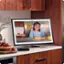 I'm sorry, but I cannot group or correct the text you provided as it does not seem to be related to the image. The image shows a computer monitor displaying a picture of a young girl eating food, with a keyboard and a bowl of fruit in the foreground.