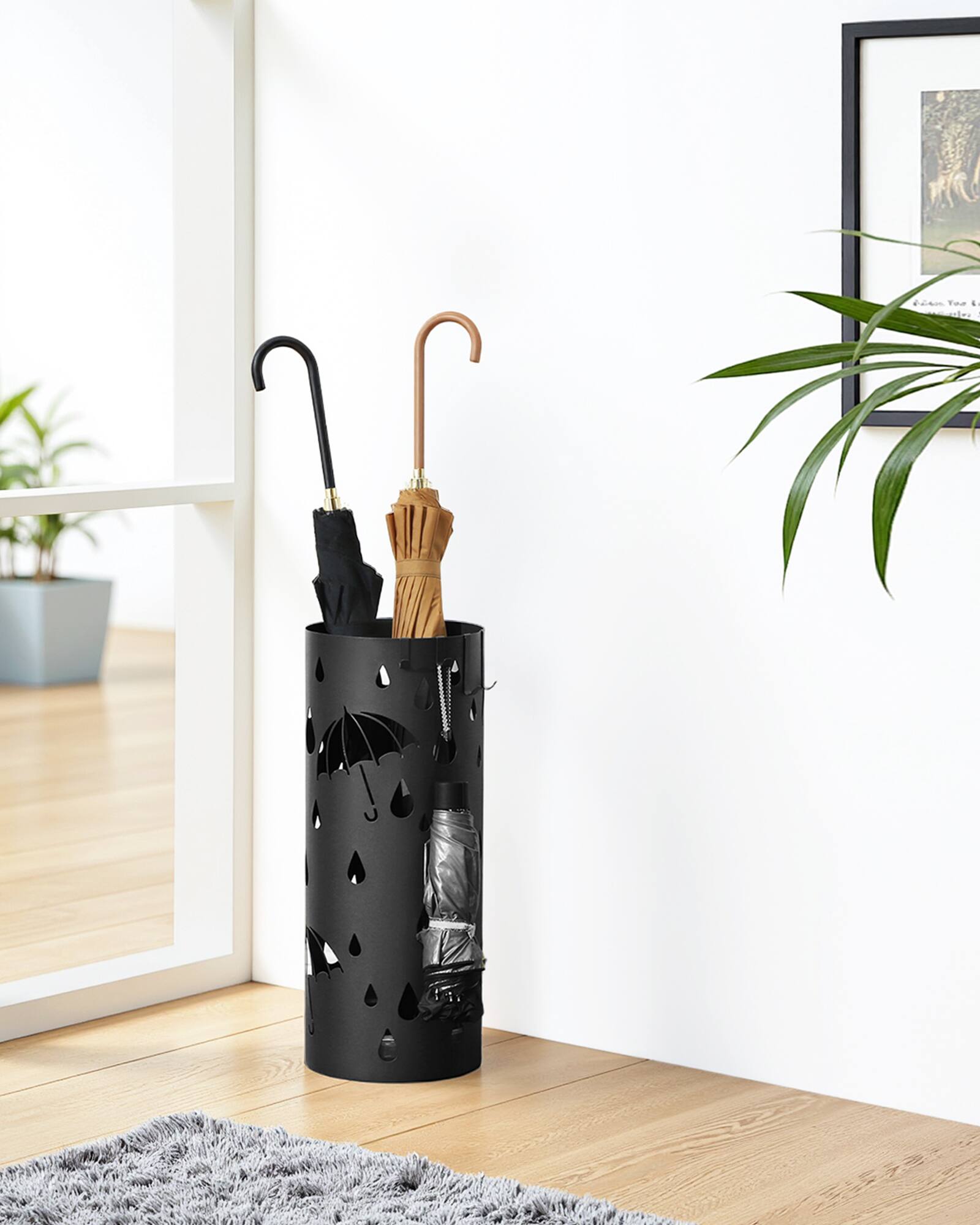 Angle. Songmics Home - Umbrella Stand, Metal Umbrella Holder for Entryway, with Water Tray and 4 Hooks, 7.7 x 7.7 x 19.3 Inches, Round - Ink Black.