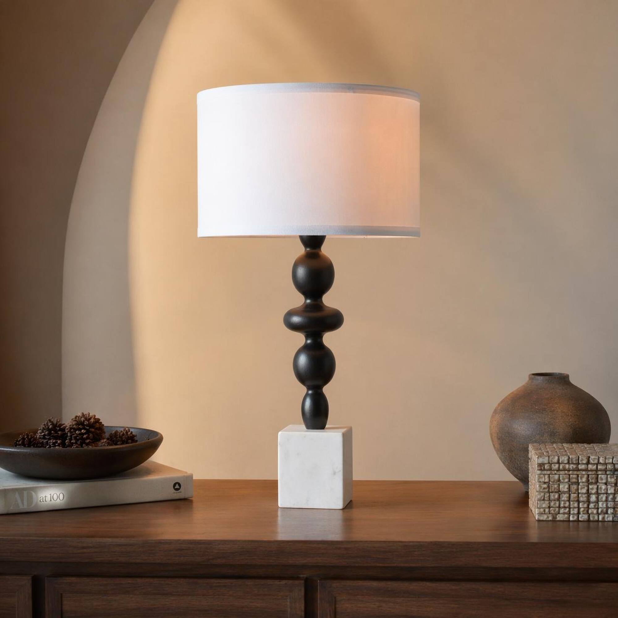 Left. RYHNUYNE - Black and White Table Lamp with Round Four-Tiered Body, Marble Cube Base, and Fabric Drum Shade - Black White.