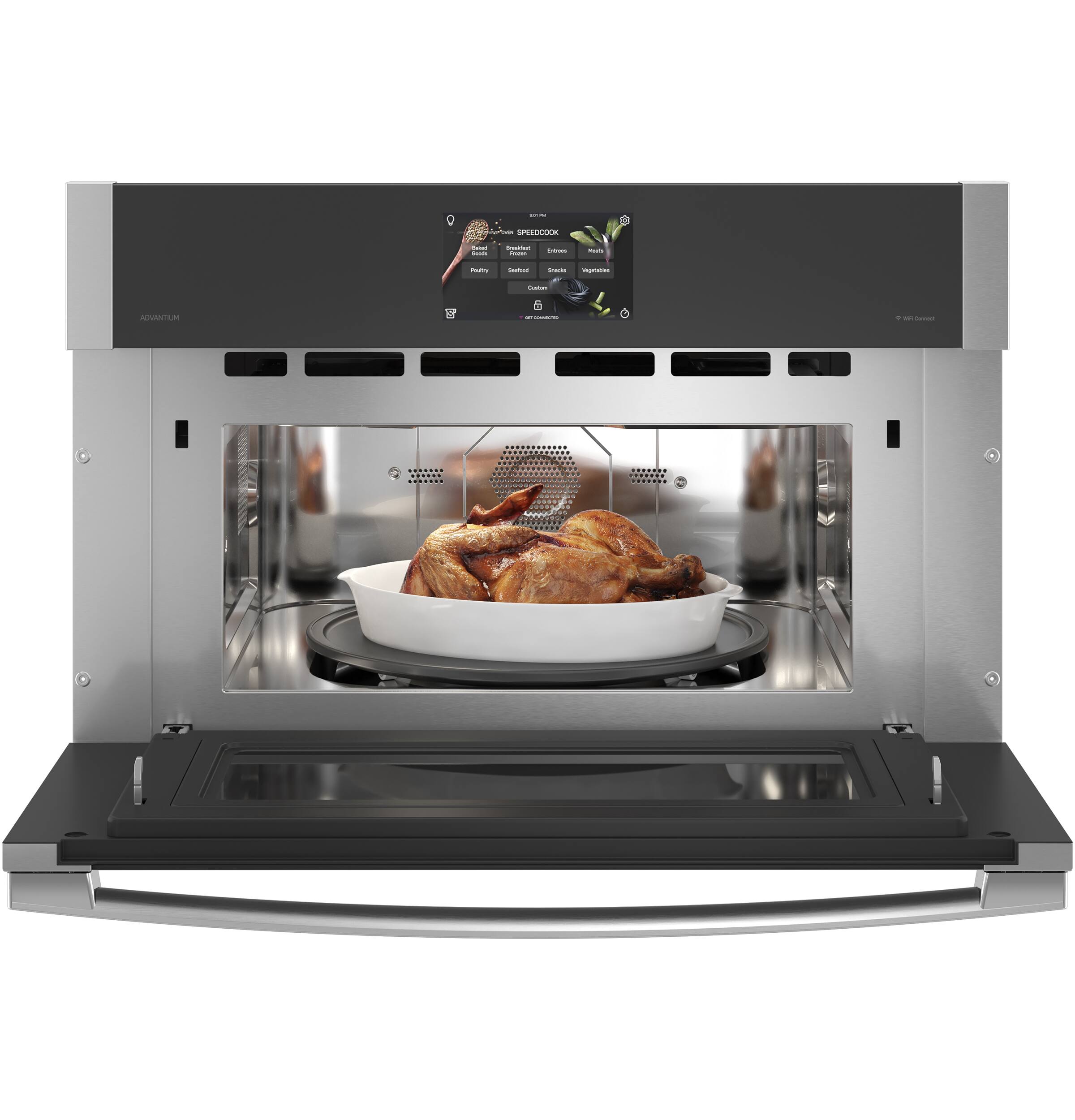 The image features a microwave with a bowl of chicken inside. The microwave is turned on, and the chicken is being cooked. The microwave is large and occupies most of the image. The chicken is placed in the center of the microwave, and the bowl is placed on top of it. The microwave is a prominent feature in the image, and the chicken is the main focus of the scene.