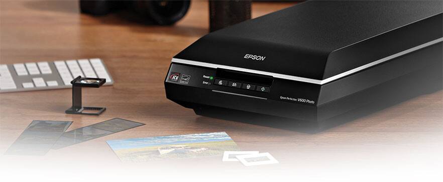 Flatbed scanner with photo prints and film on table