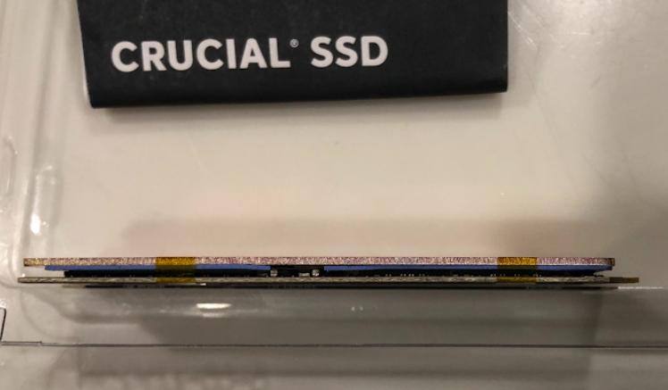 Copper heat sink w/ thermal pad (gel silica) - notice a small part of the pad is removed in the middle to clear a high spot on the SSD. Drive temps are great with a thin pad, the copper heat sink and another thicker pad touching the laptop case., click to load a larger version