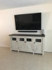 Wall mounted Samsung 65” TV sound bar above TV console, click to load a larger version
