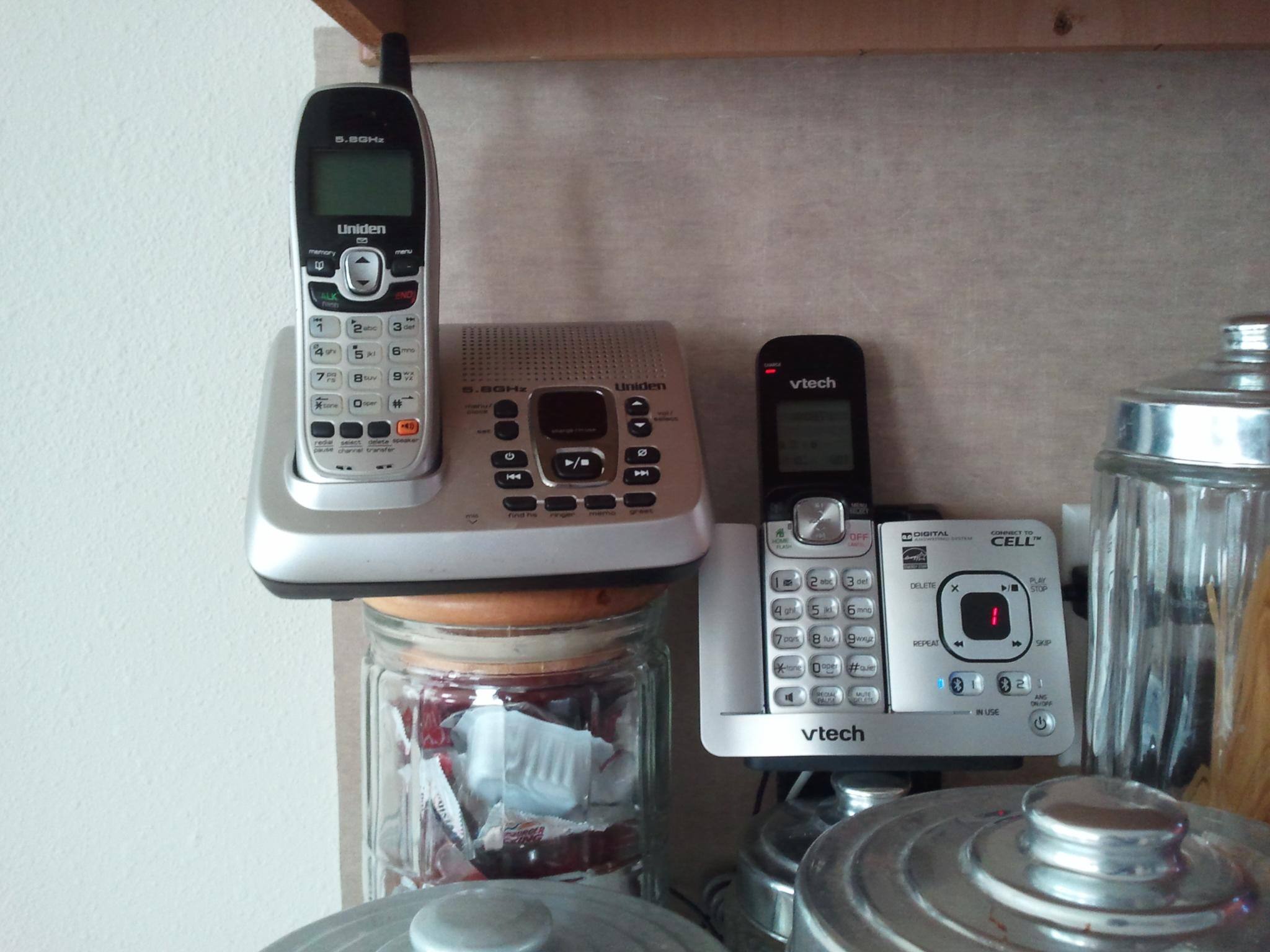 Side-by-side of both bases with their handsets. The vTech is smaller, cleaner and protrudes less., click to load a larger version