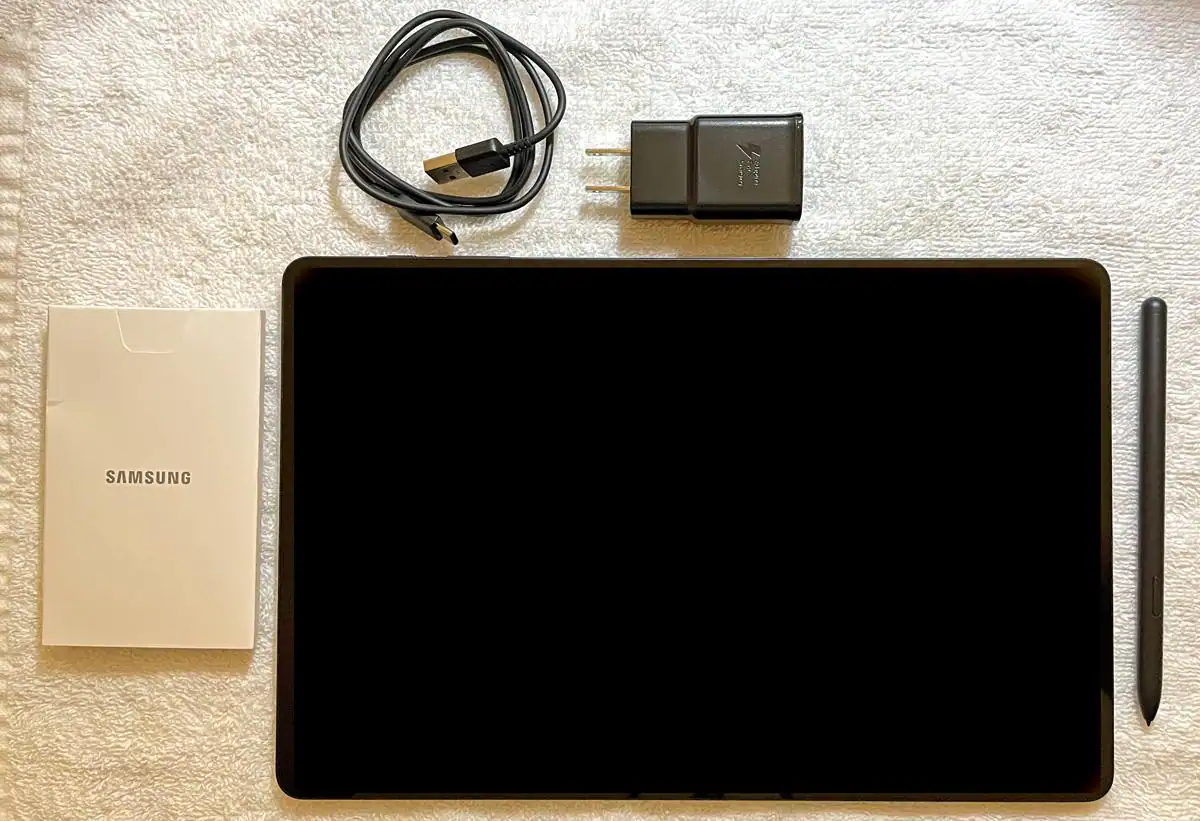 With the tablet you get the passive S-pen, a lower-wattage charger, very short charging cable, and tool to open the slot for a micro-SD card if you wish to add it., click to load a larger version