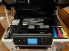 The inside of the printer with the top raised, showing where the ink refills go, click to load a larger version