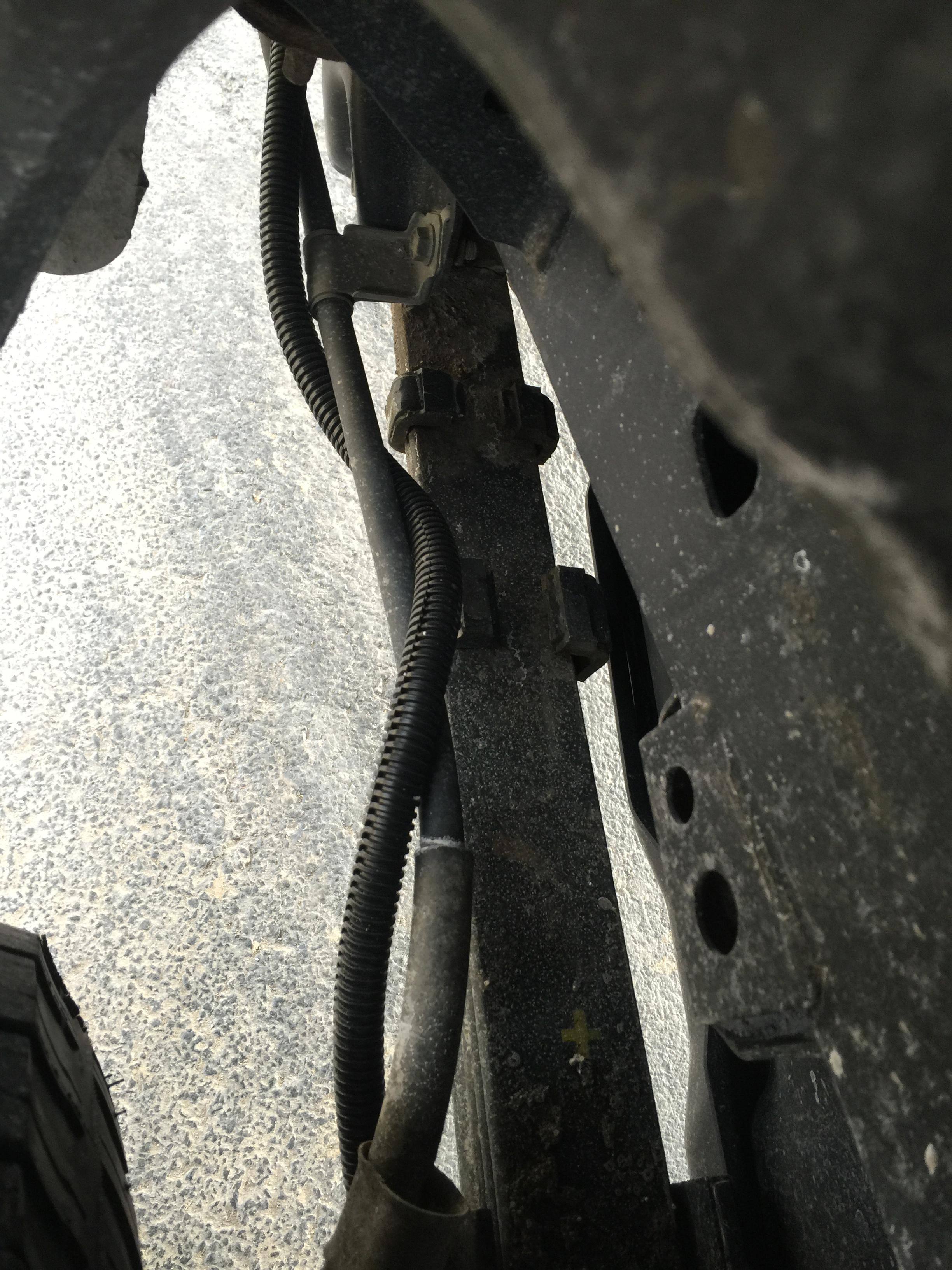wire ran around brake line and leaf spring, click to load a larger version