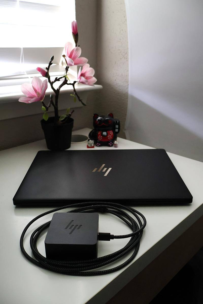 Closed laptop & charger on a desk, click to load a larger version