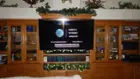 65" TV positioned flush with front of a wall unit with Kanto extendable mount, click to load a larger version