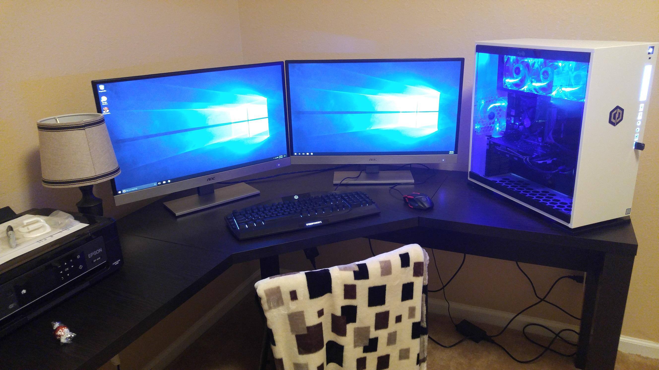 Computer desk with a huge tower and two 27 inch monitors and a printer, click to load a larger version