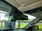 Rearview camera mounted above the mirror with cables fed over into the mirror housing. Power cable is run up to the headliner and down the passenger side pillar and under the dash to the plug., click to load a larger version
