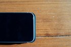 The edges of the wallet protrude beyond the edges of the phone when not in a case, and beyond the bottom of the phone when in a case., click to load a larger version