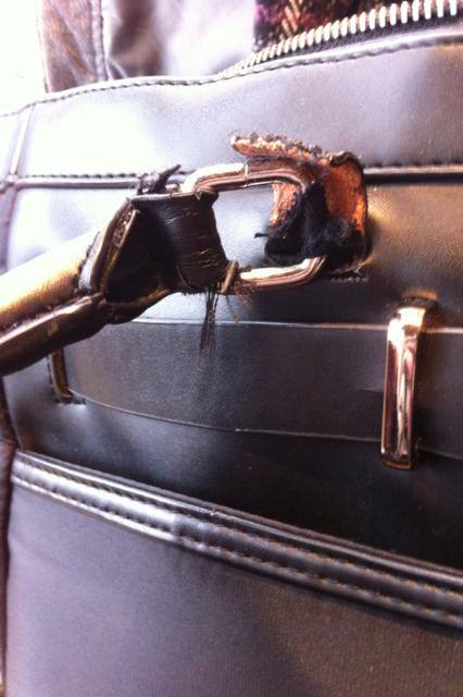 Faux leather is torn, fabric beneath is ready to tear., click to load a larger version