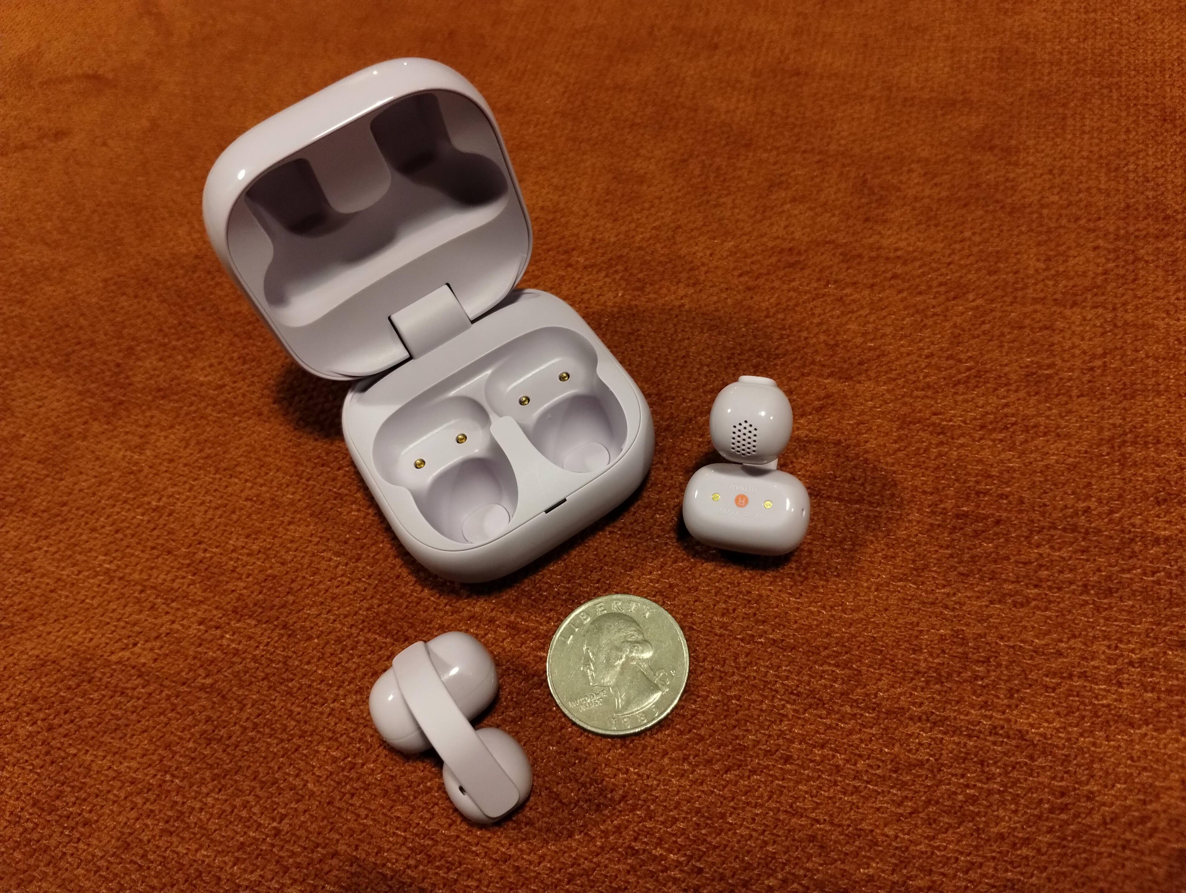 Case Open, left and right ear bud, you can see the red circle with the "R" for "Right" on the Right ear bud.  The left has a white circle with an "L" in it.  There is a quarter there to give an idea of the size., click to load a larger version