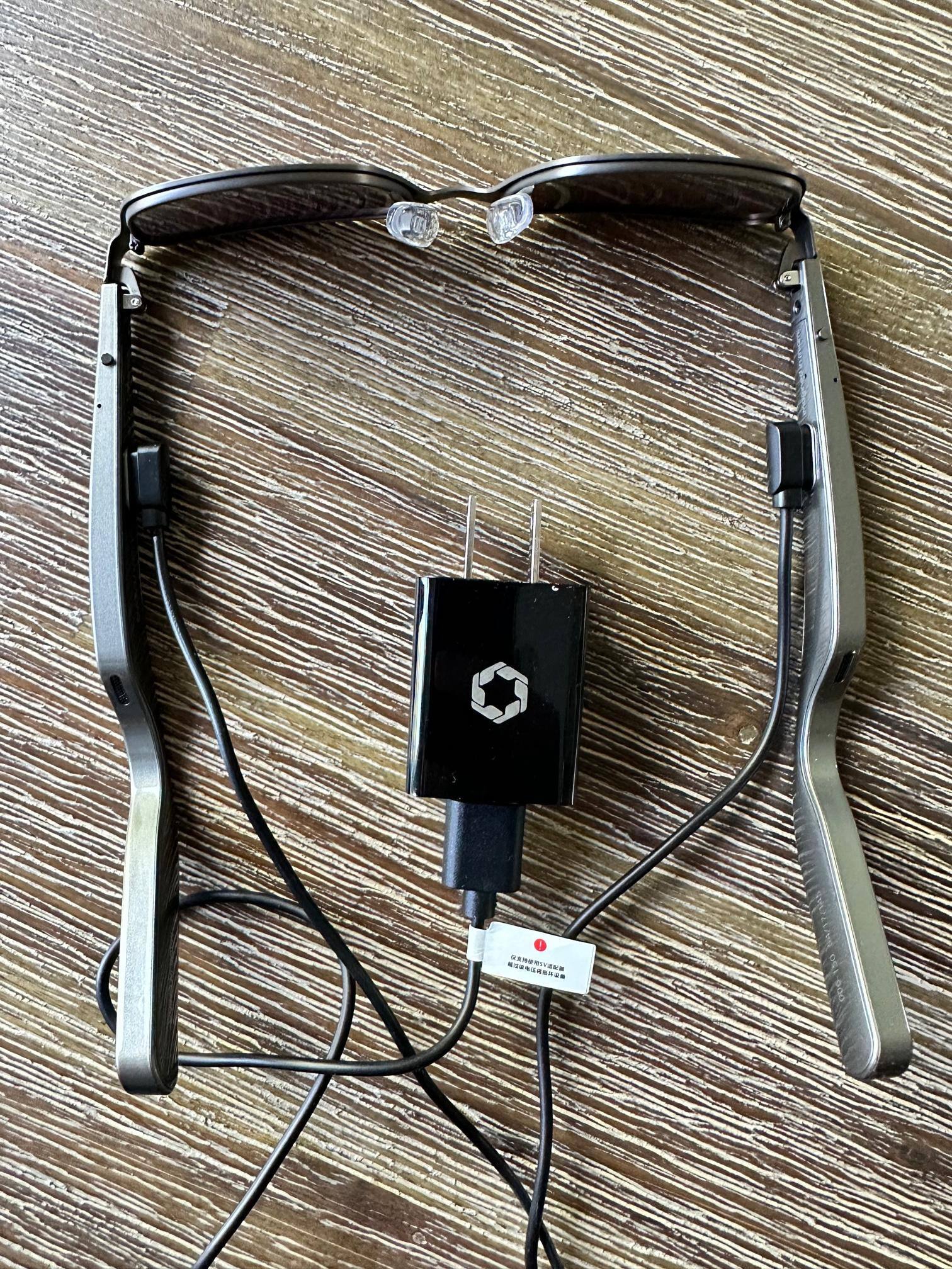 Comes with wall plug.  Need to charge both temples., click to load a larger version