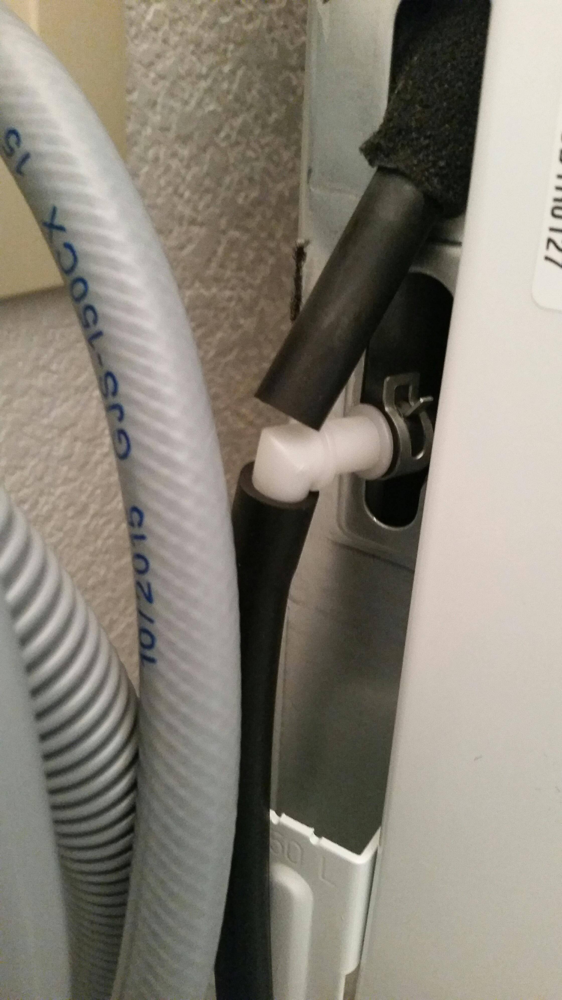 The grey hoses go to the washer. See the white "L" piece? Connects to the household drain. While the black tube on the very top, that goes to the reservoir, is connected to nothing., click to load a larger version