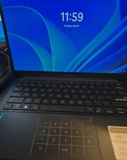 Laptop, vibrant screen, built in number pad on touch pad. On/off toggle to activate., click to load a larger version