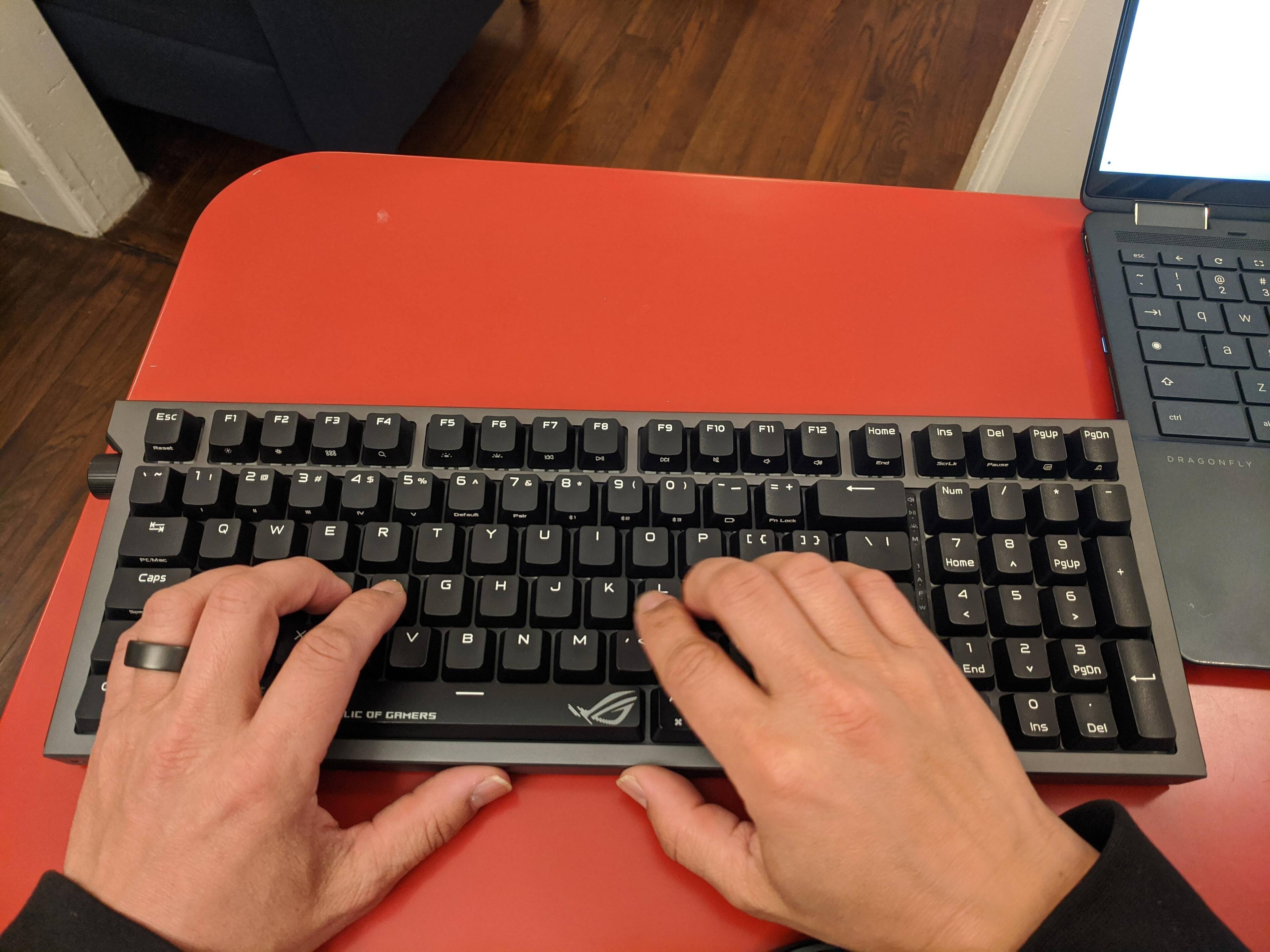 I have smaller hands and the keyboard doesn't overwhelm me. I like how they gained a few mm from the compressed layout., click to load a larger version