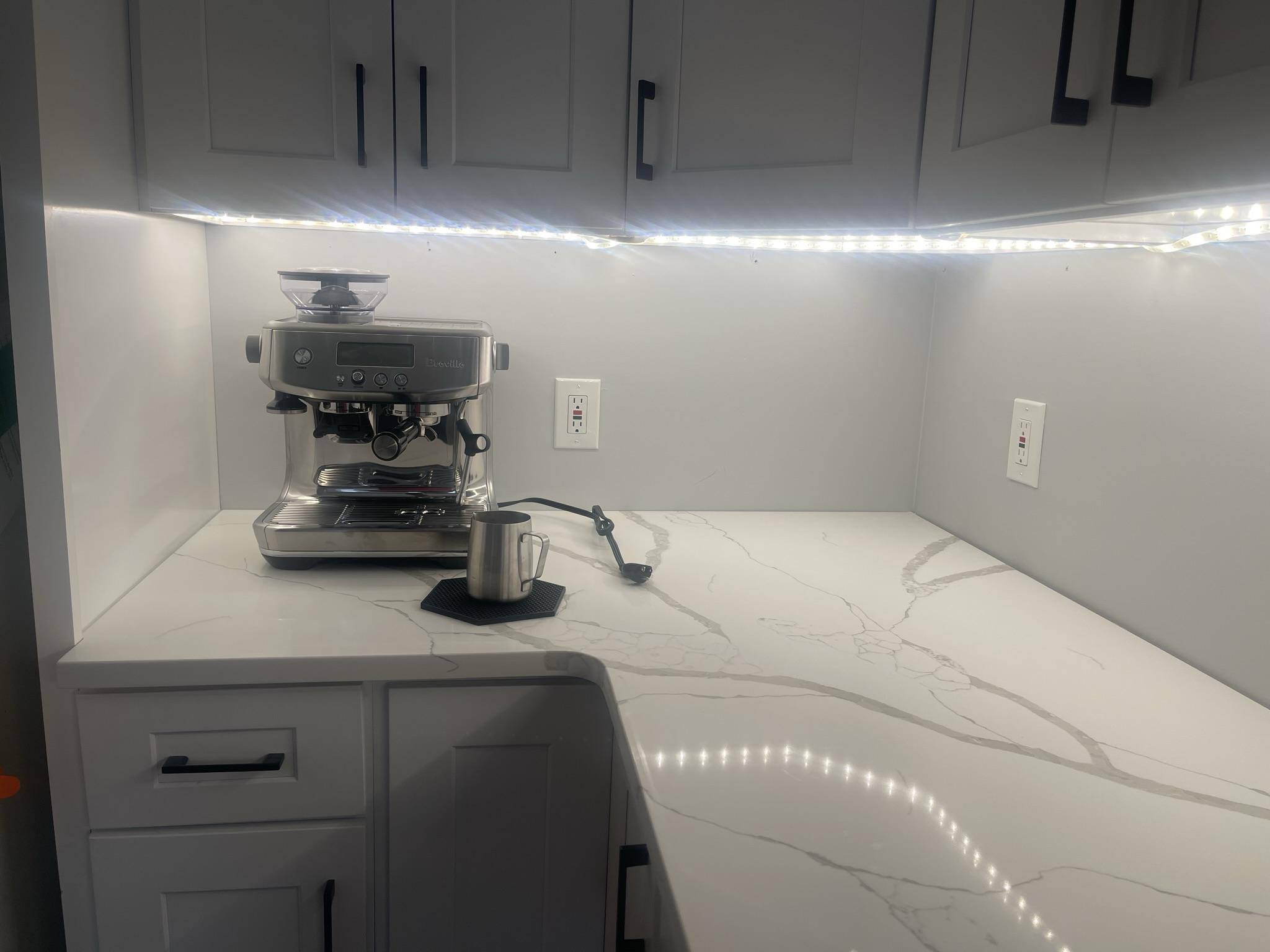Breville Barista Pro installed beneath cabinets on a wide kitchen counter