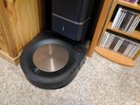 Even with the charging dock tucked away under a desk, Puck the Roomba has no trouble figuring out its way home., click to load a larger version