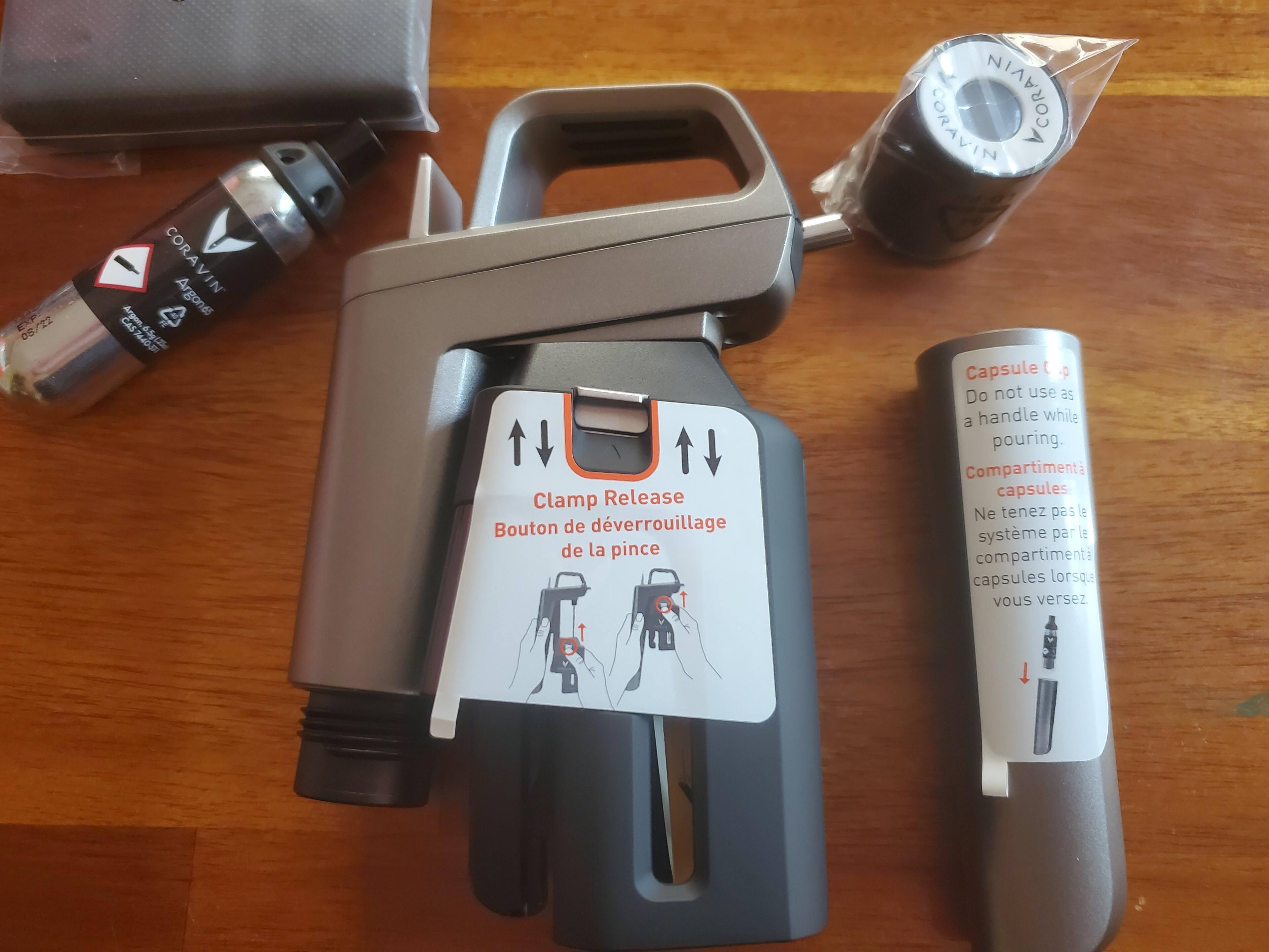 The black "shiny" panel that is covered by a sticker protector, along with an Argon Gas Capsule and the "screw cap" adapter, click to load a larger version