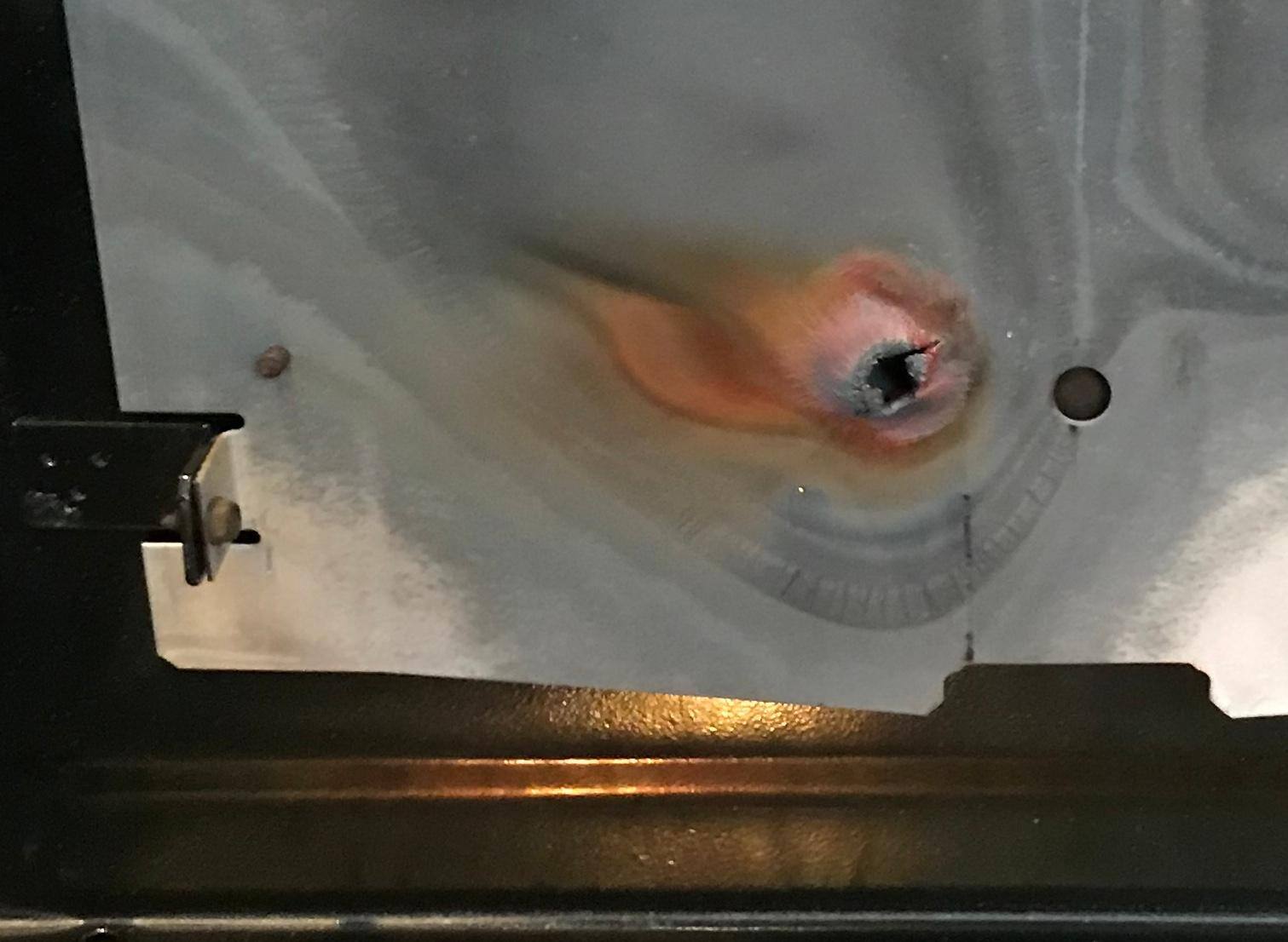 Lower oven heat deflector - poorly designed so it overheats and melts. GE would send the part, but refused to pay for labor to fix this., click to load a larger version