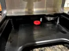 Storage for cleaning needle and extra portafilter under drip tray, click to load a larger version