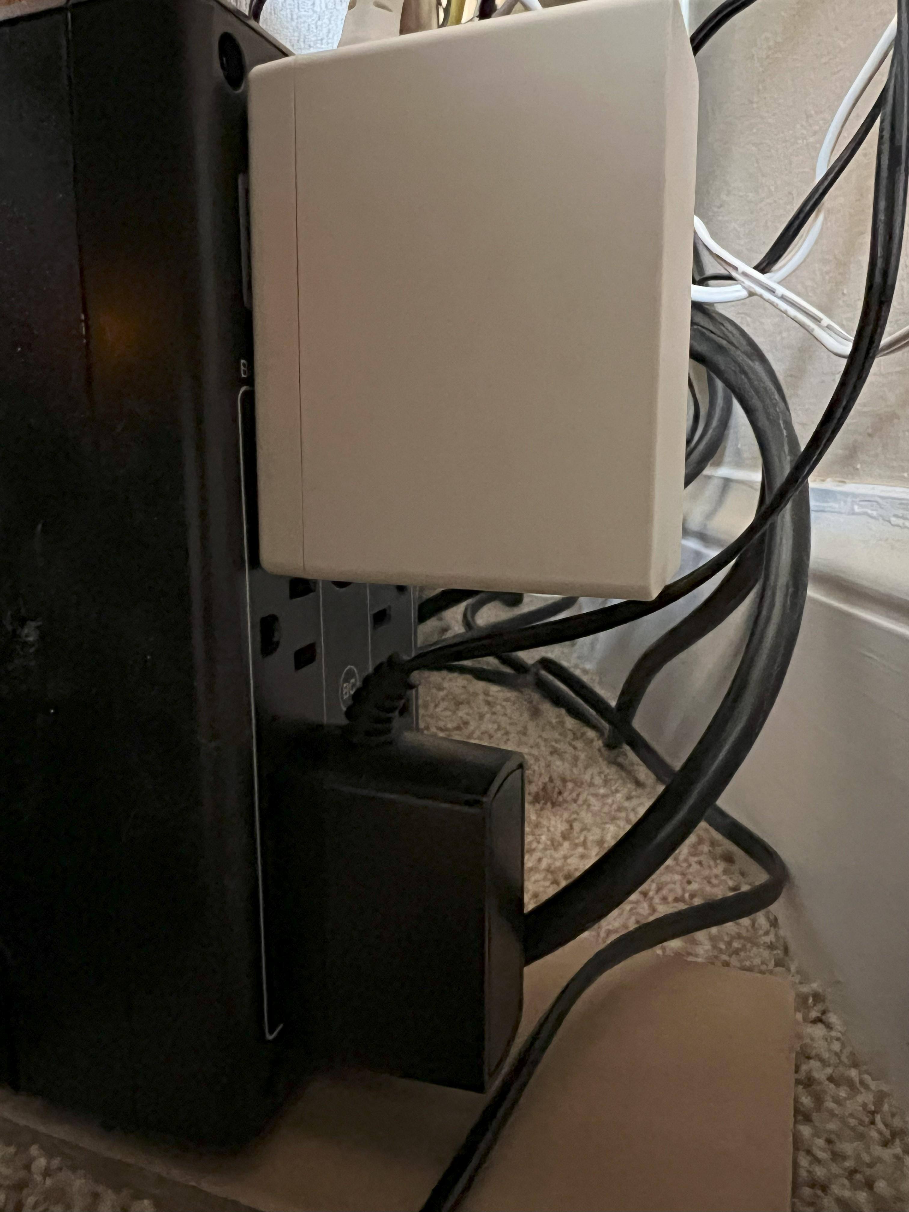 Power adapter for router and modem blocking other two outlets., click to load a larger version