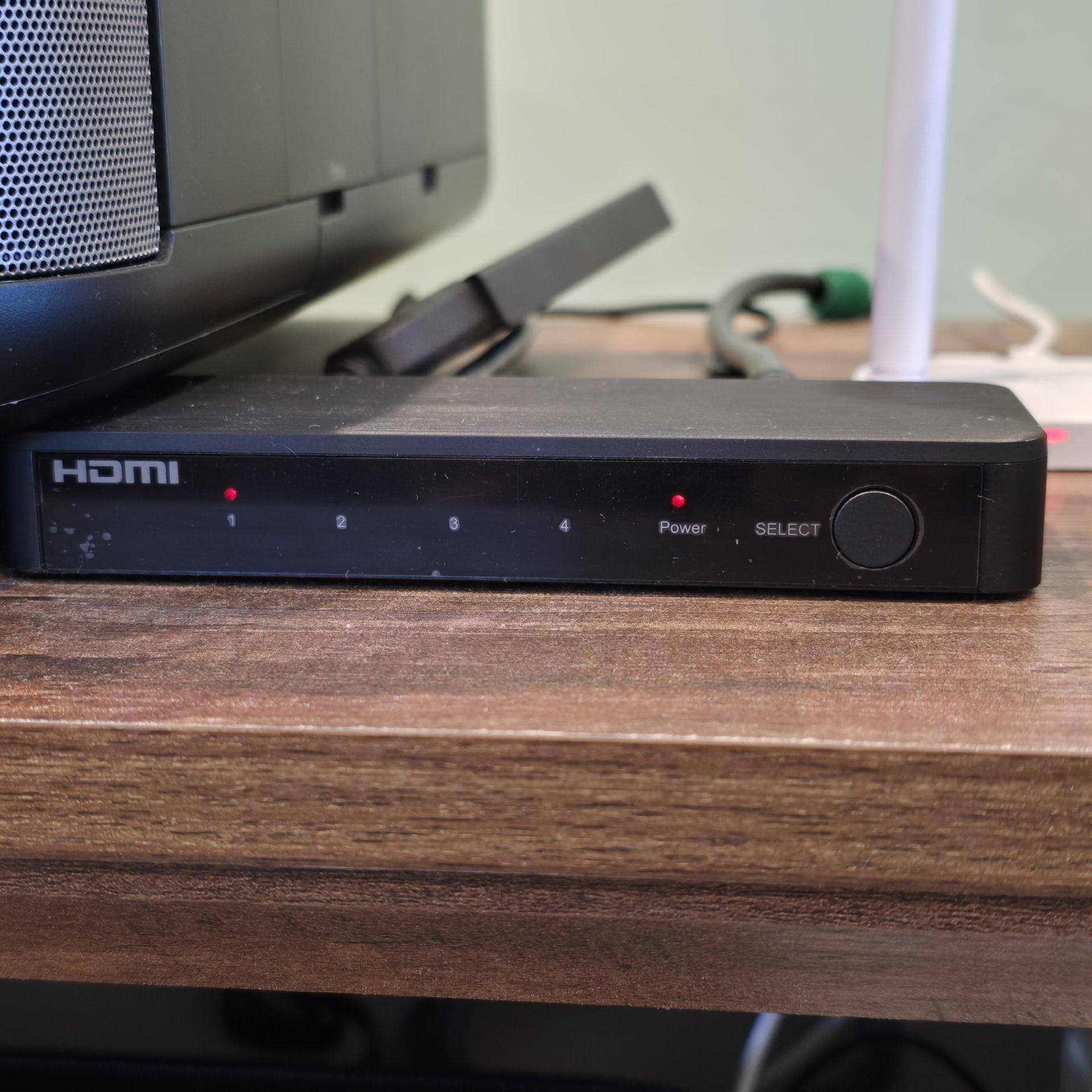 4-port switch beside projector with multiple inputs at the rear, click to load a larger version