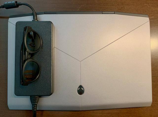 Size comparison of charger with sunglasses and laptop., click to load a larger version