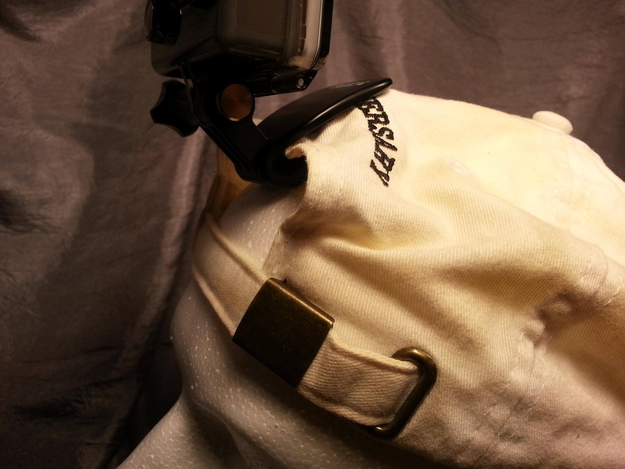 QuickClip with camera attached to a baseball cap. Cap shown fits too loosely, so camera is not secure., click to load a larger version
