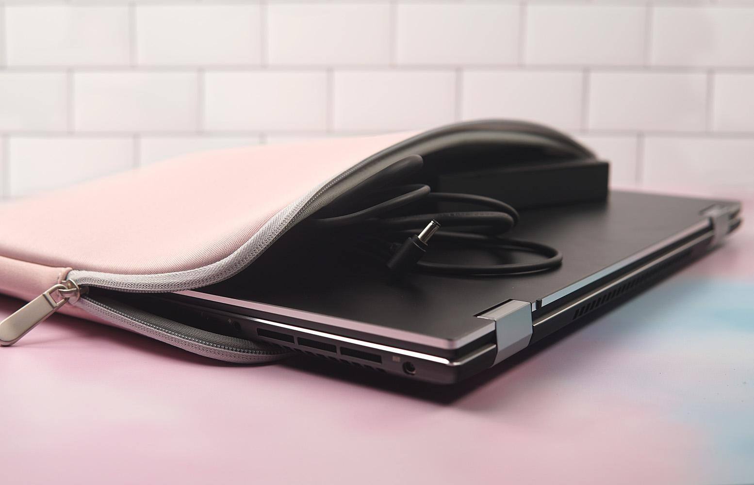 View of the open sleeve with a laptop and charging cable inside., click to load a larger version