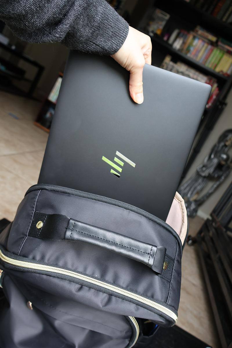 HP Dragonfly Pro being taken out of a backpack, click to load a larger version