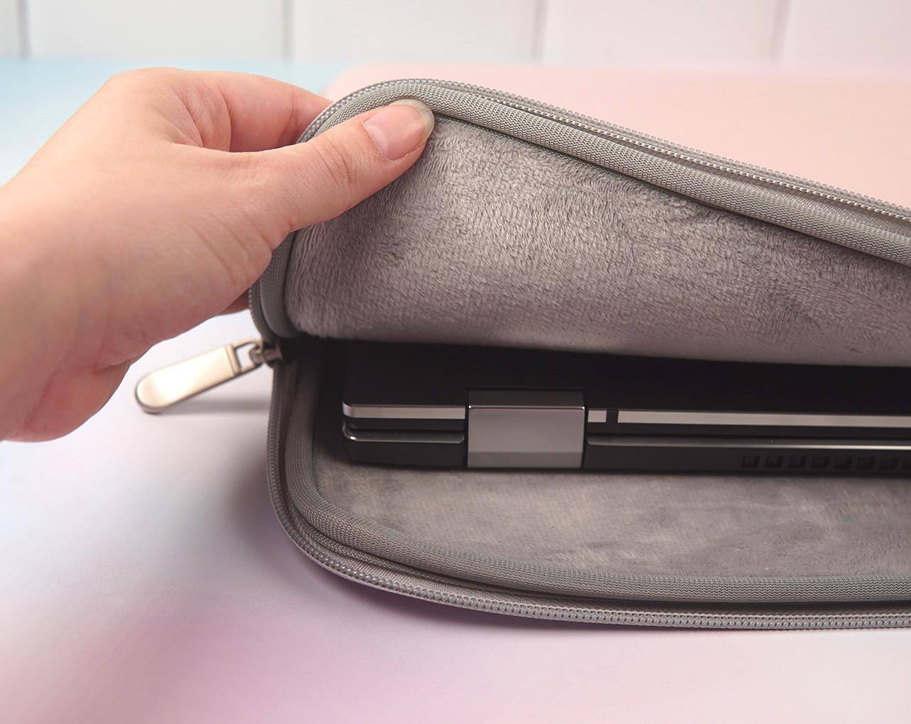 View of the grey plush interior with a laptop inside., click to load a larger version