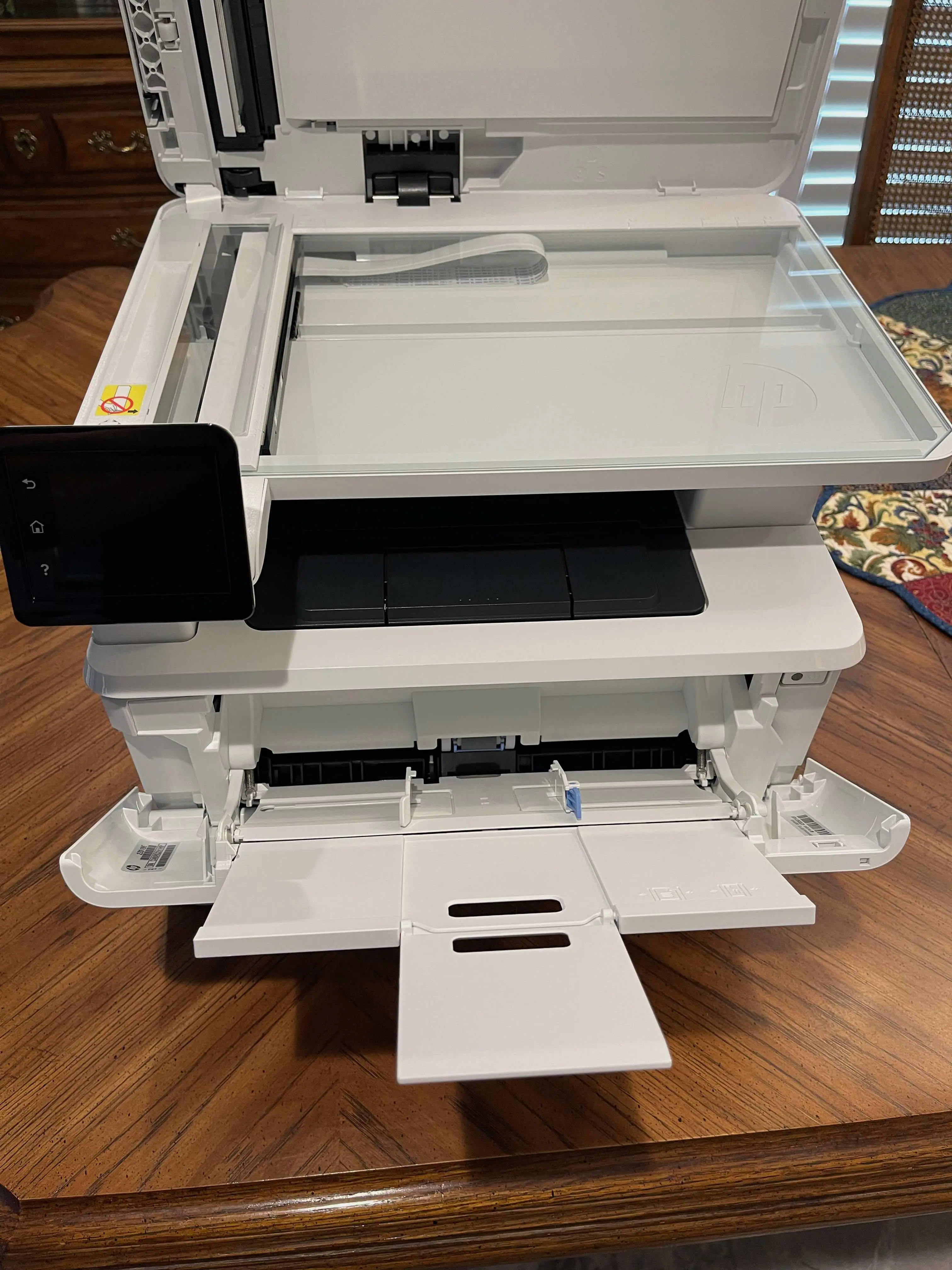 Top down of printer showing platen, paper output area, display and paper input bypass., click to load a larger version