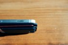 The edges of the wallet protrude beyond the edges of the phone when not in a case, and beyond the bottom of the phone when in a case., click to load a larger version