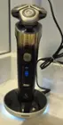 The charging pad lights up to indicate charging as does the bar around the head of the shaver for providing guiding on pressure and motion., click to load a larger version