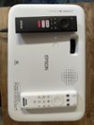 Top of projector with both remotes and built in speaker, click to load a larger version