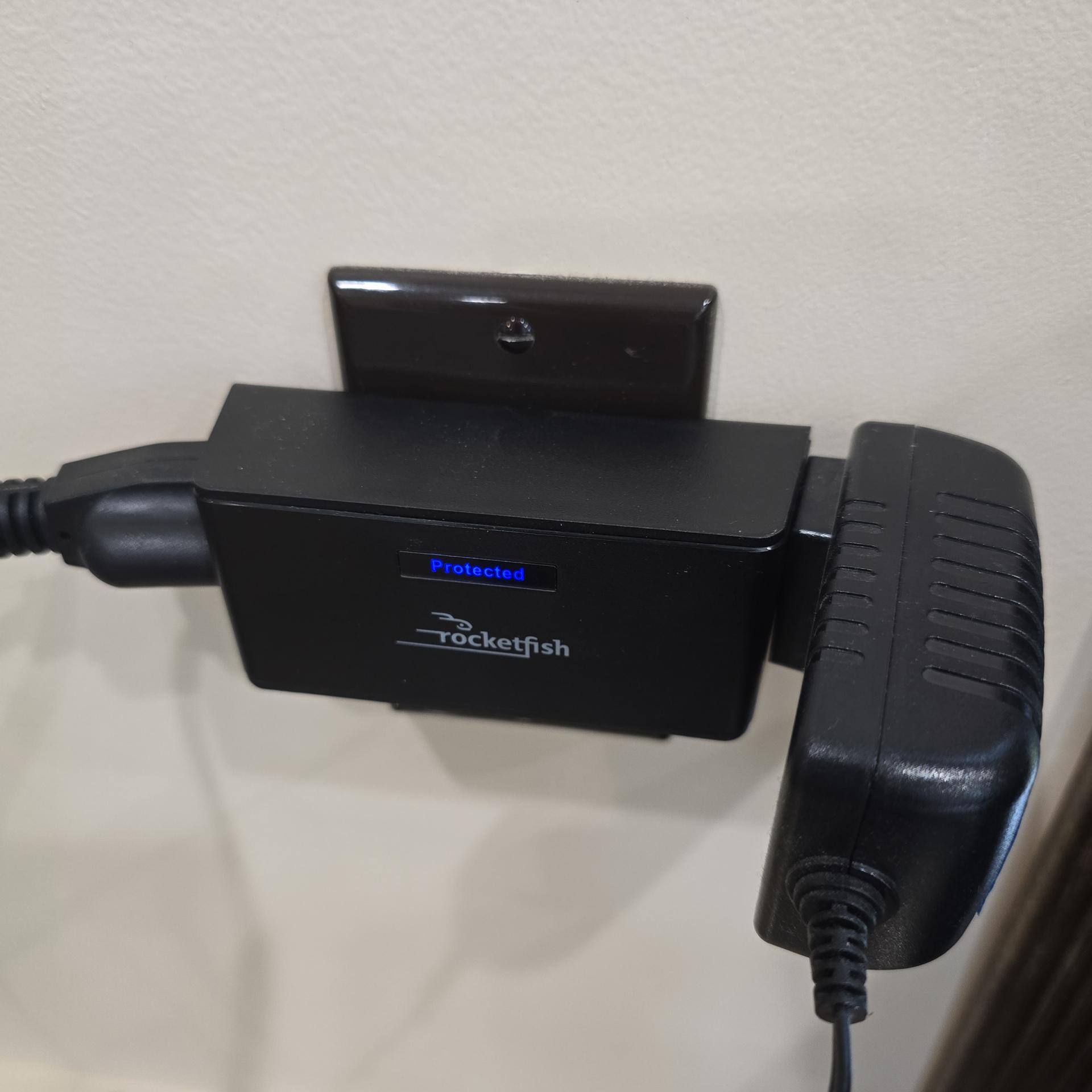 Rocketfish 2-outlet surge protector with 2 devices plugged in, including a bulky AC adapter, click to load a larger version