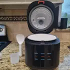 Rice cooker with lid open is approximately 19" tall. Rice paddle/scoop stands up on its end. A 1 cup measuring cup is included., click to load a larger version