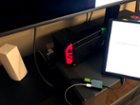 Close-up of dongle charging tablet while displaying to TV, click to load a larger version