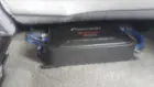 Under the Driver's Seat. Left side is RCA and Bass Boost Remote, right side is the Power, Ground and Sub, I believe., click to load a larger version