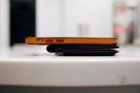 This is a thick wallet. Pictured is an iPhone 13 Mini., click to load a larger version