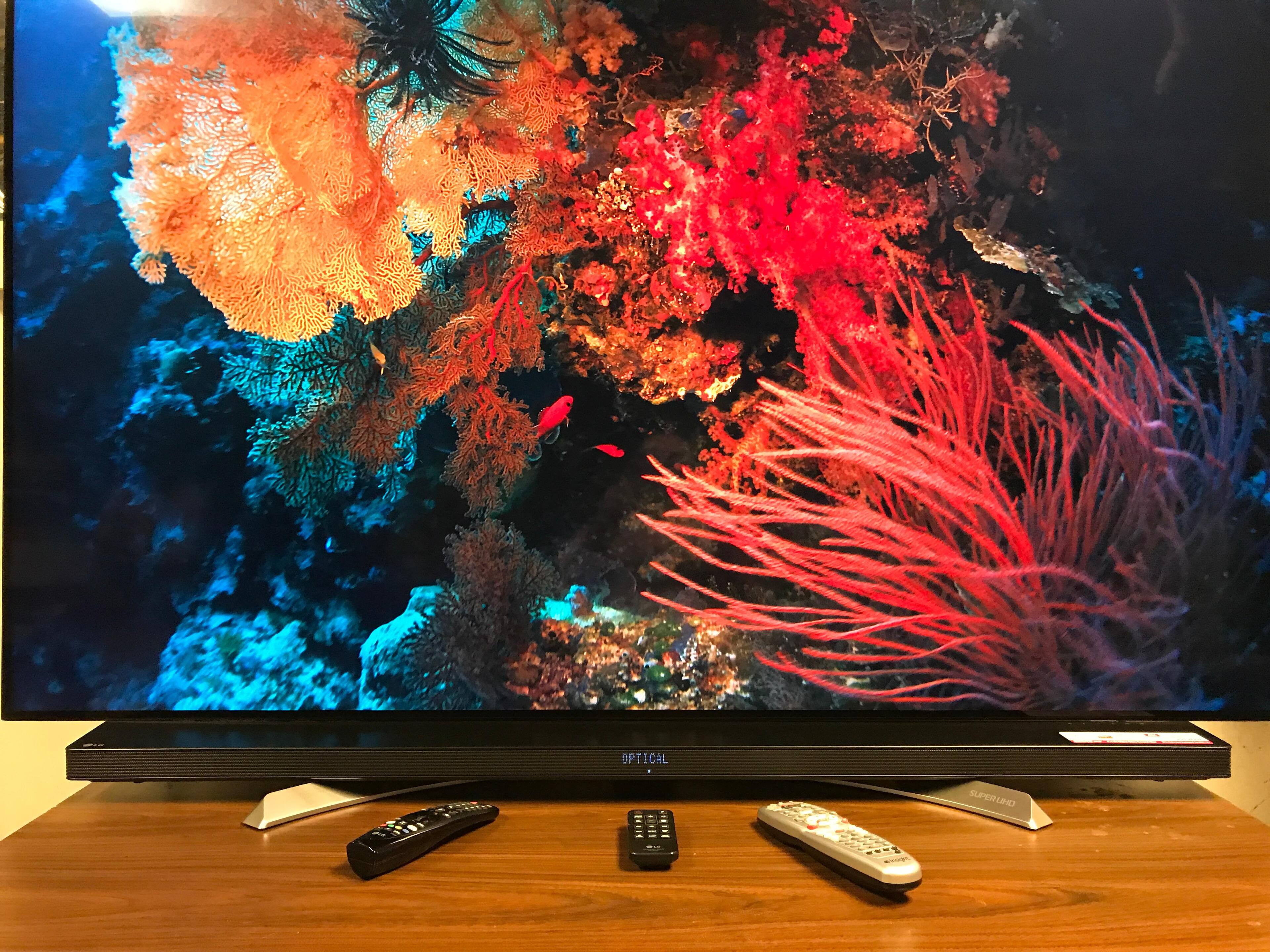 The low profile Soundbar sits on the feet of the LG TV, completely below the TV for an integrated look., click to load a larger version