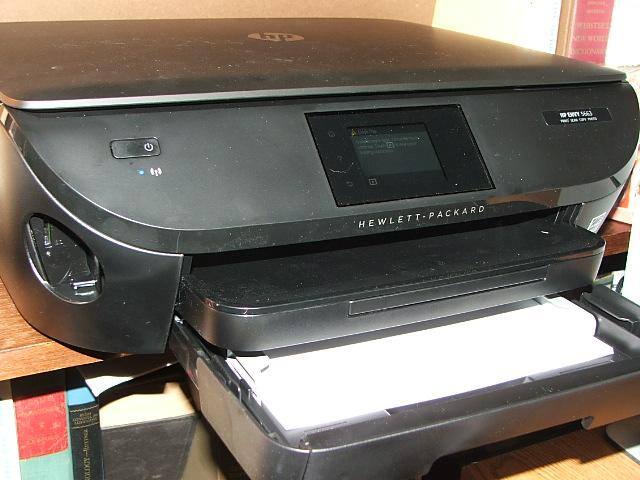 Paper tray will push shut. Loaded with 8.5-11 copy paper. The photo tray (other photo) is pushed forward where is stays when not used. Easy to load both or change to 14” Note the SD card slot, it’s cover door will close when not used., click to load a larger version