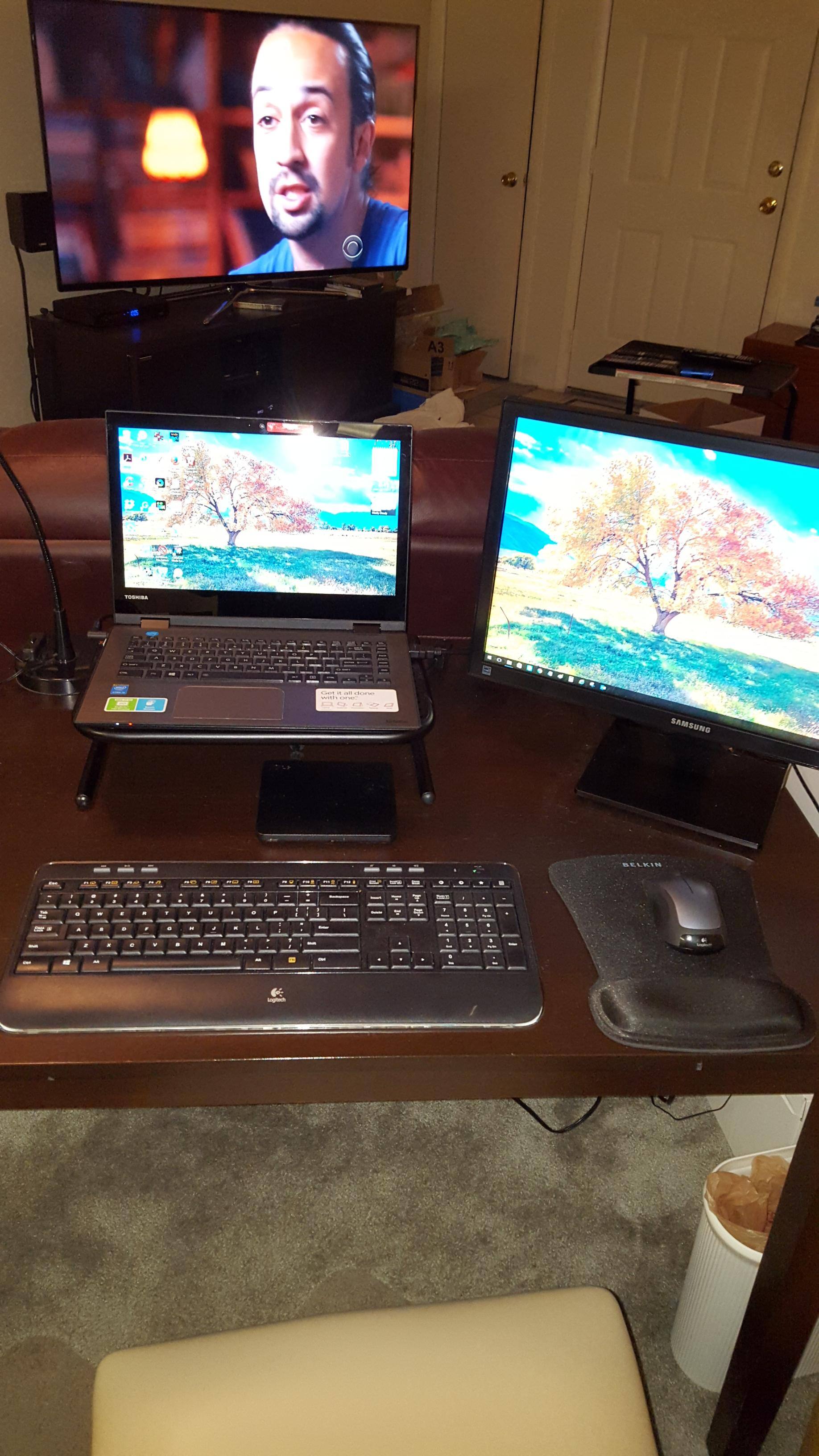 My desktop w/TV in background, click to load a larger version