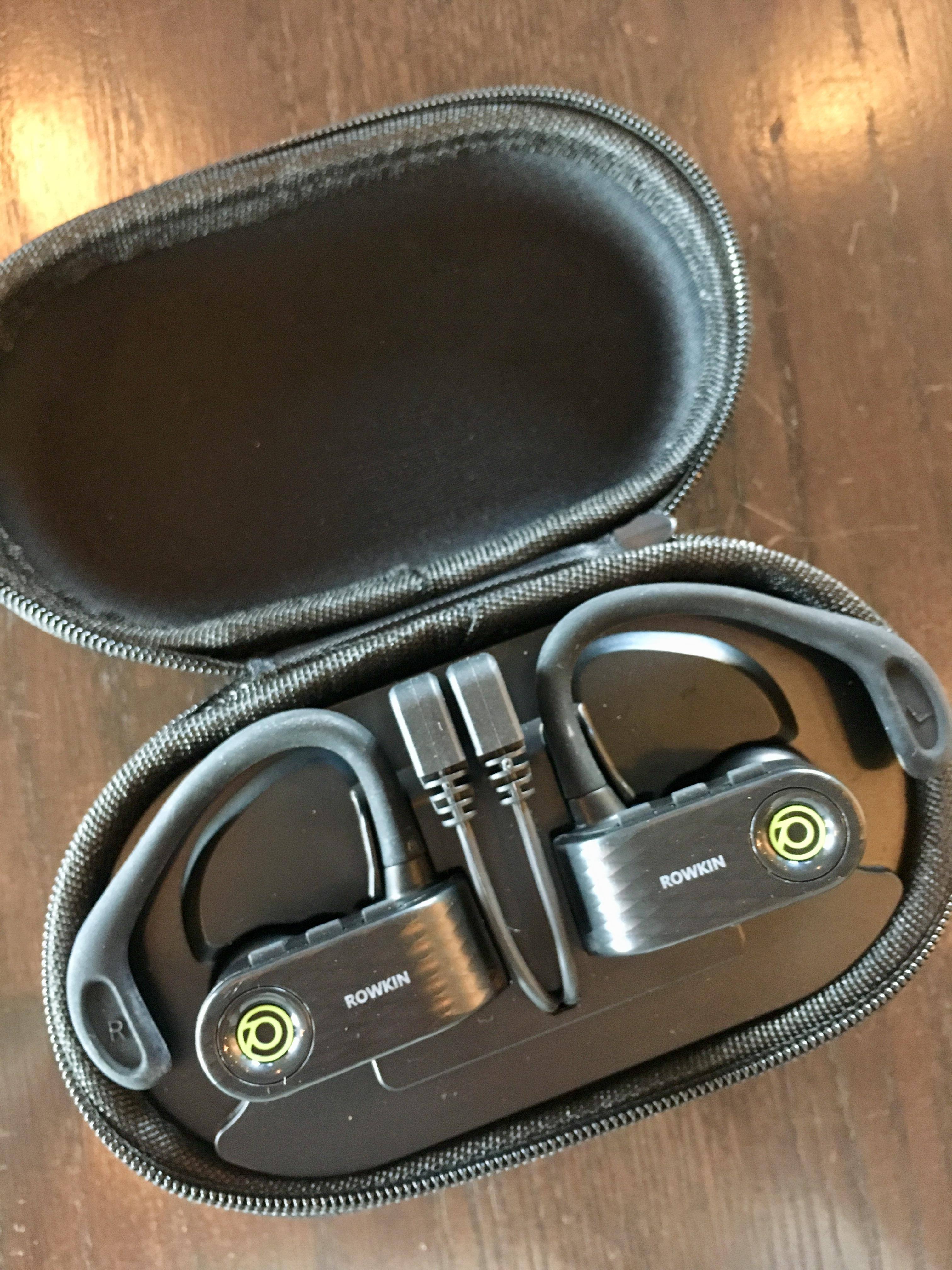 Headphones in charging case, click to load a larger version
